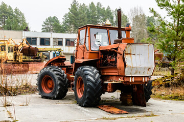 Fototapeta na wymiar Abandoned soviet tractor at the Chernobyl exclusion zone, Ukraine