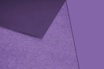 Plain and Textured blue purple papers randomly laying to form M like pattern and triangle for creative cover design idea