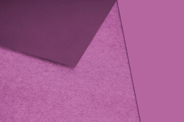 Plain and Textured pink papers randomly laying to form M like pattern and triangle for creative cover design idea