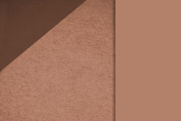 Textured and plain tan brown sheet papers forming two triangles and vertical blank rectangle for creative cover designing
