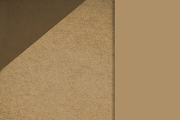 Textured and plain yellow brown sheet papers forming two triangles and vertical blank rectangle for creative cover designing
