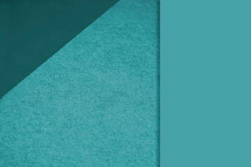 Textured and plain ocean blue sheet papers forming two triangles and vertical blank rectangle for...