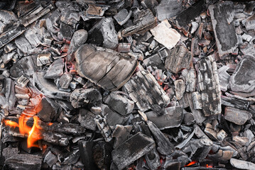 Burning coals texture background close up.