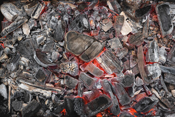 Burning coals texture background close up.