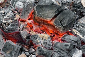Burning coals texture background close up.