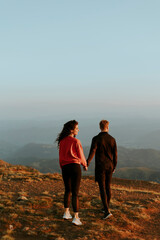 Young couple traveling together and hiking in the mountains