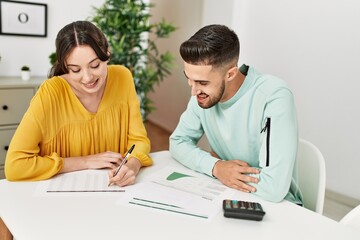 Obraz premium Young couple controlling family economy at home.