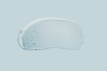 Liquid gel abstract cosmetic smudge on blue background. Smear of transparent moisturizing product