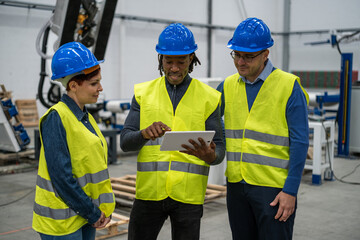 Engineers exchanging knowledge in the robotics factory