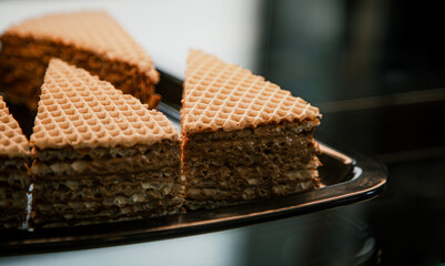 Pieces of waffle cake on display in a cafe.