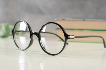 Fototapeta na wymiar Stylish glasses for vision in a black round frame on the table