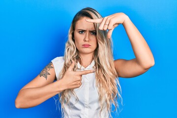 Beautiful young blonde woman doing picture frame gesture with hands skeptic and nervous, frowning upset because of problem. negative person.