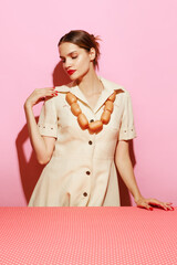 Portrait of young woman having necklace made from sausages. Creative food advertisement