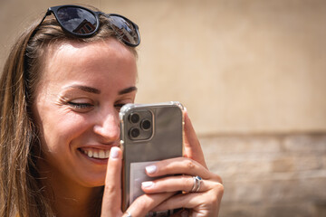 A young woman takes a photo on a smartphone, close-up.