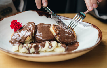 Close-up, delicious pancakes with chocolate and banana for breakfast.