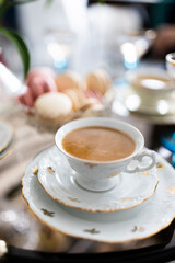 A dessert table setting with macaroons, coffee and champagne all in a light atmosphere Nr.6