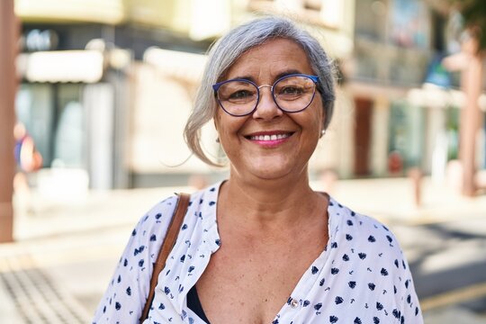 Middle age woman smiling confident standing at street