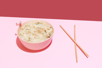 Delicious image of noodles isolated over pink background. Japanese cuisine