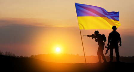 Flag of Ukraine with silhouette of soldiers against the sunrise or sunset. Concept - armed forces of Ukraine. Relationship between Ukraine and Russia.