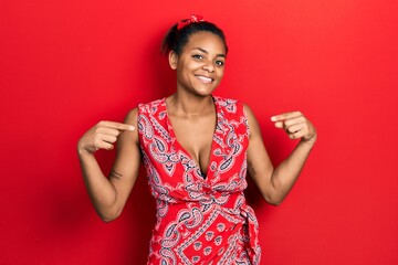 Young african american girl wearing casual clothes looking confident with smile on face, pointing oneself with fingers proud and happy.