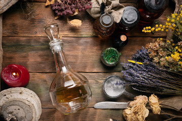 Herbal medicine concept background. Dry natural ingredients and remedy bottle on the wooden table...