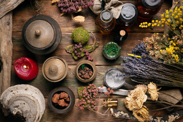 Obraz na płótnie Canvas Herbal medicine concept background. Dry natural ingredients and remedy bottle on the wooden table flat lay background.