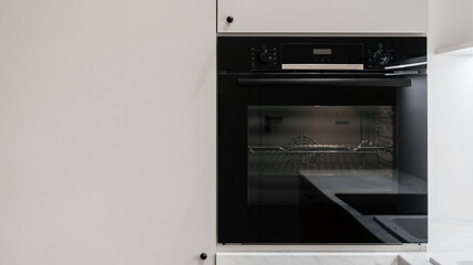 Built-in electric oven on modern white kitchen