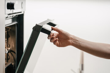 Housewife open door in electric oven, checking baked goods