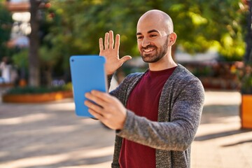 Fototapeta premium Young man smiling confident having video call at park