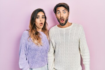 Young hispanic couple wearing casual clothes afraid and shocked with surprise and amazed...