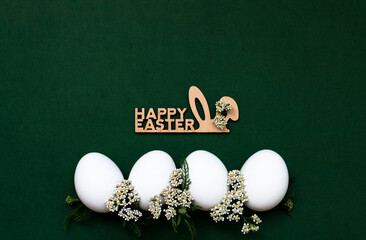 Festive Easter eggs with white small flowers on a green background. - 519198137