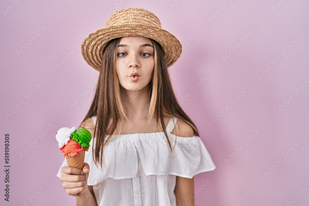 Sticker teenager girl holding ice cream making fish face with lips, crazy and comical gesture. funny express