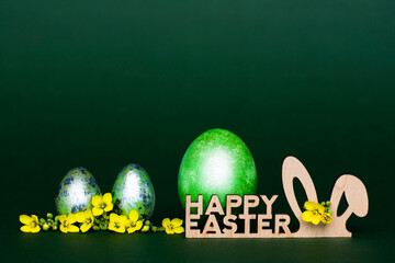 Wooden inscription Happy Easter, stylized bunny ears on a green background, - 519198550