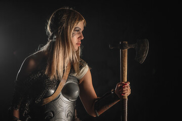 Obraz na płótnie Canvas Beautiful woman warrior with the axe concept.