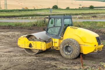 Heavy Vibration roller at compaction pavement works during road repairing. Construction of a new road. Compaction road roller. Construction works.