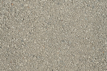 Small rocks ground texture background. white road stone. gravel pebbles stone texture. crushed granite. close up. grey clumping clay. cat litter