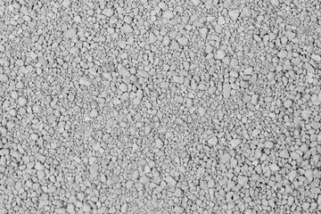 Small rocks ground texture background. white road stone. gravel pebbles stone texture. crushed granite. close up. grey clumping clay. cat litter