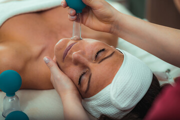 Cupping therapy, ventosa cupping face treatment in a beauty salon