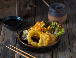 VEGETABLE TEMPURA served in a dish isolated on wooden background side view