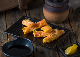 KANI TEMPURA served in a dish isolated on wooden background side view