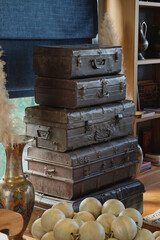 Interior design decorated  with vintage suitcases set and wooden craft art works, bronze vase