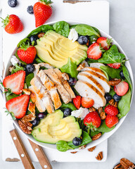 Healthy Chicken Salad with Avocado, Spinach, Blueberries and Pecan Nuts. Healthy lunch menu. Diet food. Top view