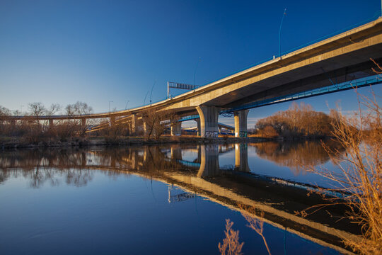 the Zbraslav Bridge in Prague, which used to be called the Peace Race Bridge. The bridge is crushed in the Vltava river. Photographed in autumn under a clear sky.