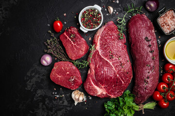 beef meat background fillet steaks with herbs and spices on a dark background. Restaurant menu,...
