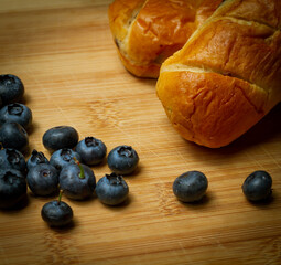 blueberries with small sweet bakes all shown on bamboo cutting board