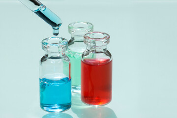 Perfume production. Set of bottles with reagents and pipette on lab table.