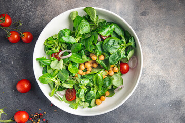 chickpea salad legumes, lettuce, mache, tomato fresh healthy meal food snack diet on the table copy space food background rustic 