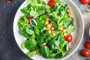 chickpea salad legumes, lettuce, mache, tomato fresh healthy meal food snack diet on the table copy space food background rustic 