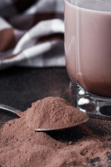 chocolate cocoa milk powder on a black stone background