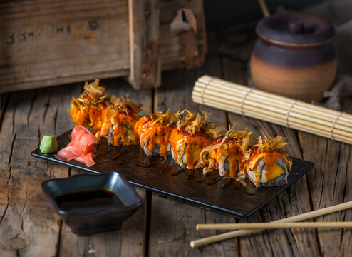 HANAKO maki served in a dish isolated on wooden background side view